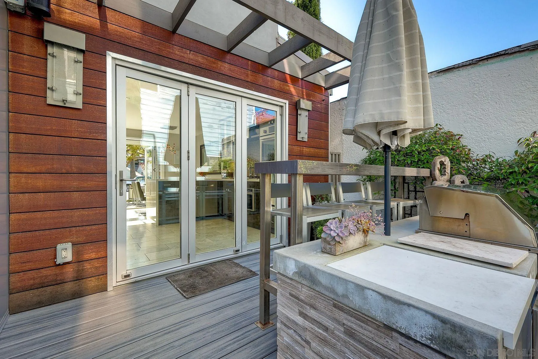 911 9th Street Coronado, CA 92118 - Photo 22 of 45 a view of a porch with furniture and wooden floor