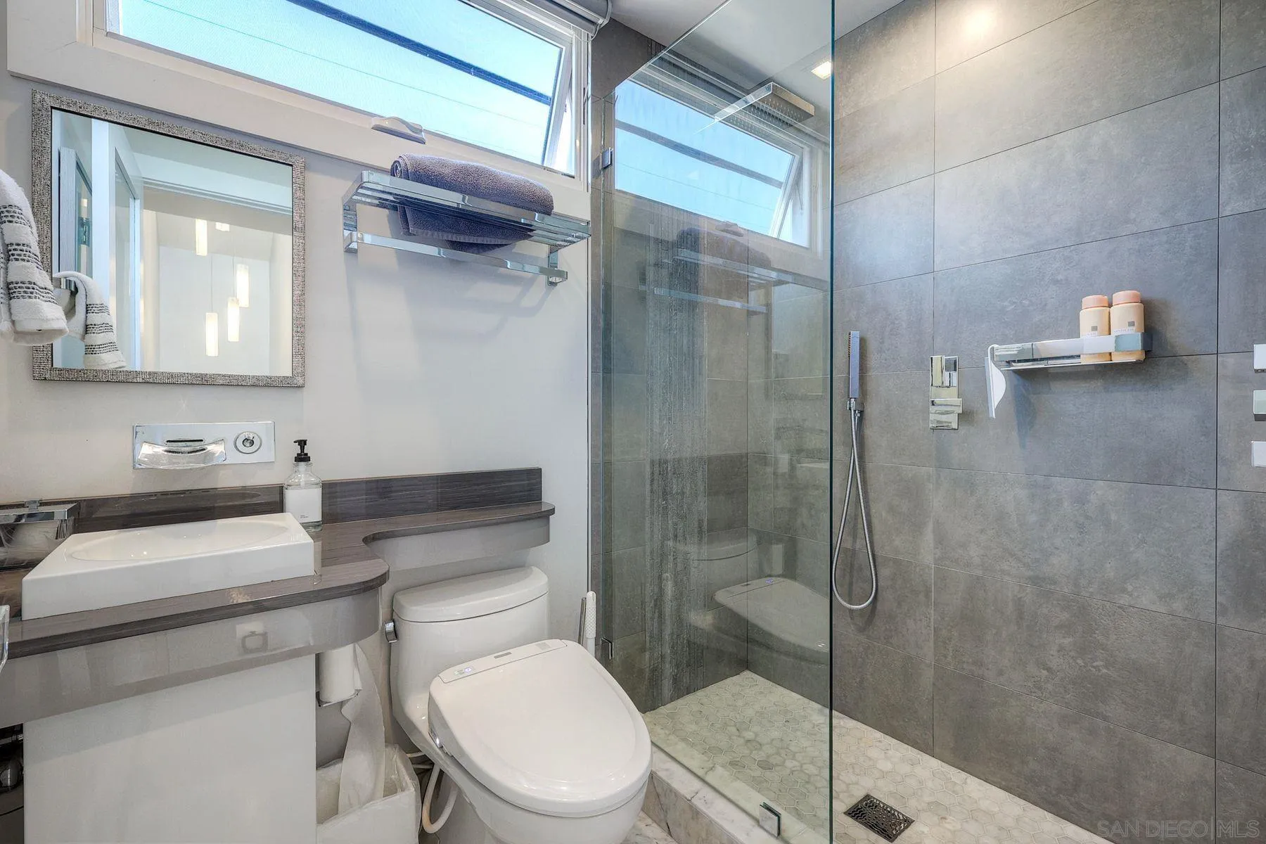 911 9th Street Coronado, CA 92118 - Photo 25 of 45 a bathroom with a sink toilet and shower