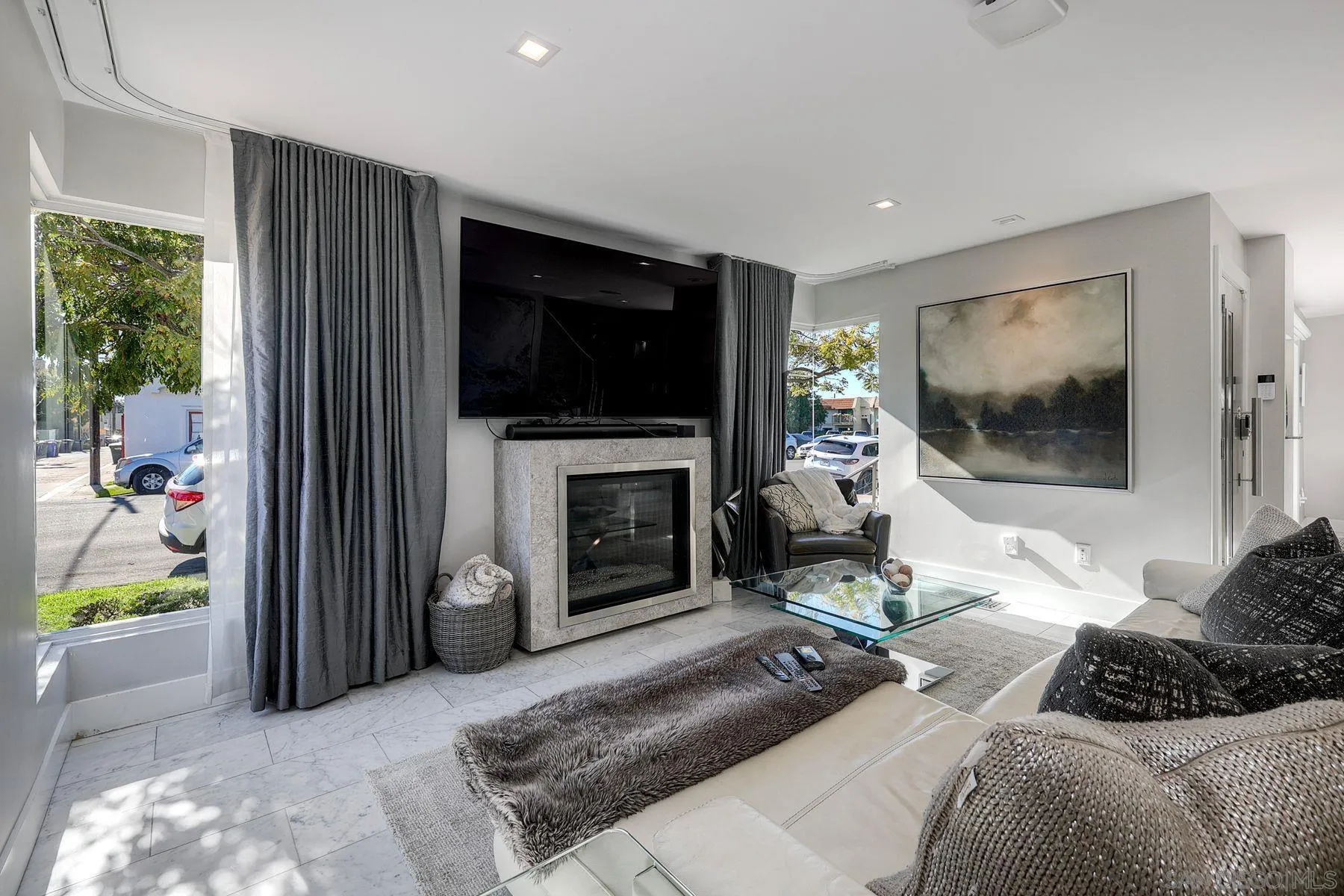 911 9th Street Coronado, CA 92118 - Photo 34 of 45 a living room with furniture a fireplace and a flat screen tv
