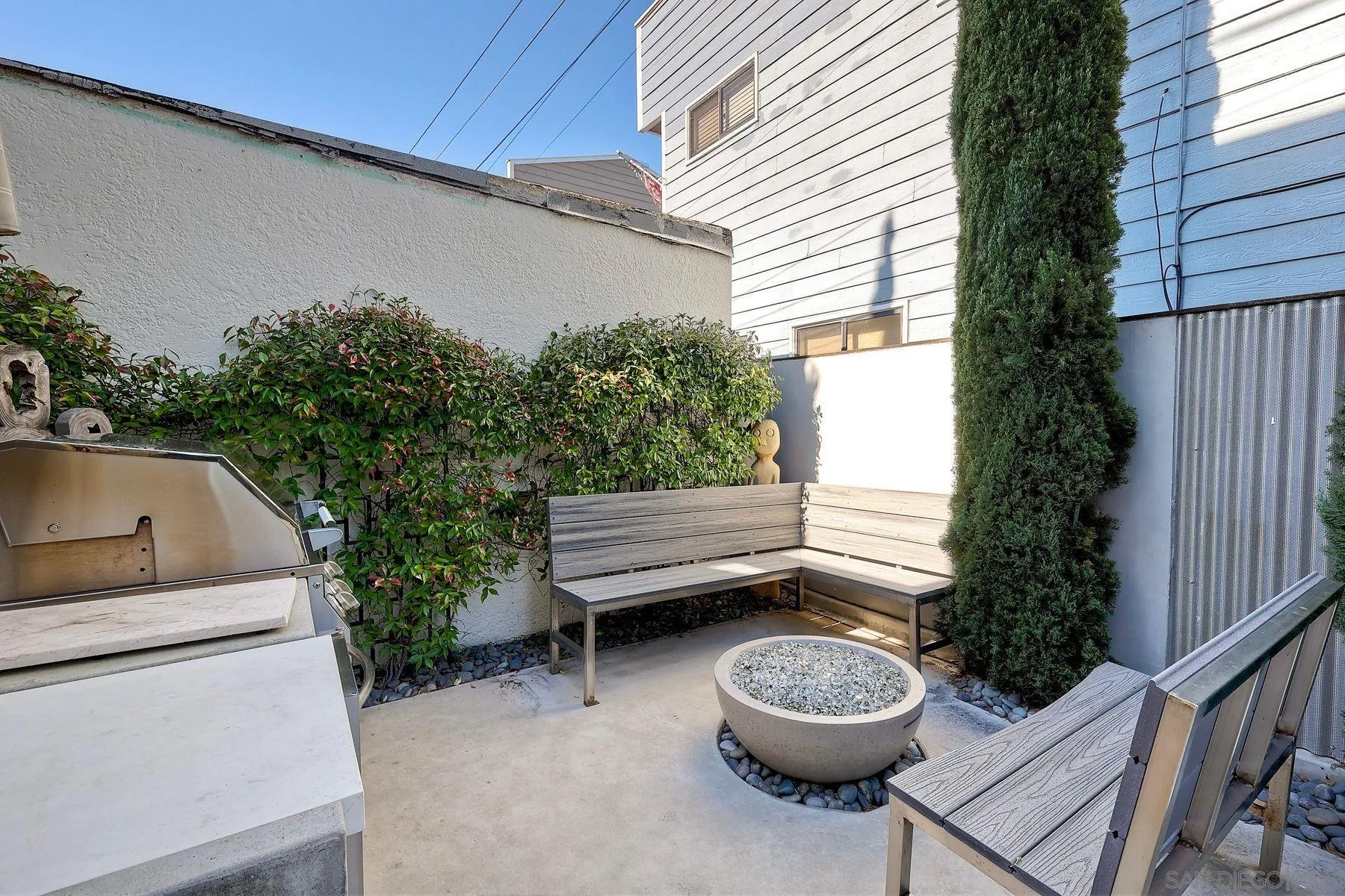 911 9th Street Coronado, CA 92118 - Photo 10 of 45 a backyard of a house with a sink and a potted plant