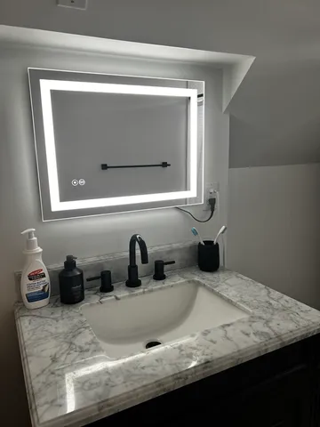 a bathroom with sink and mirror