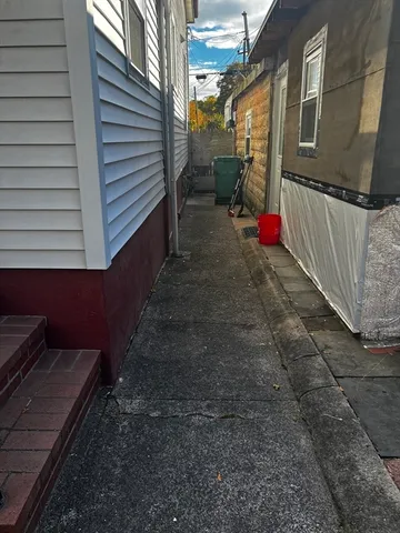 a backyard of a house with lots of green space and plants