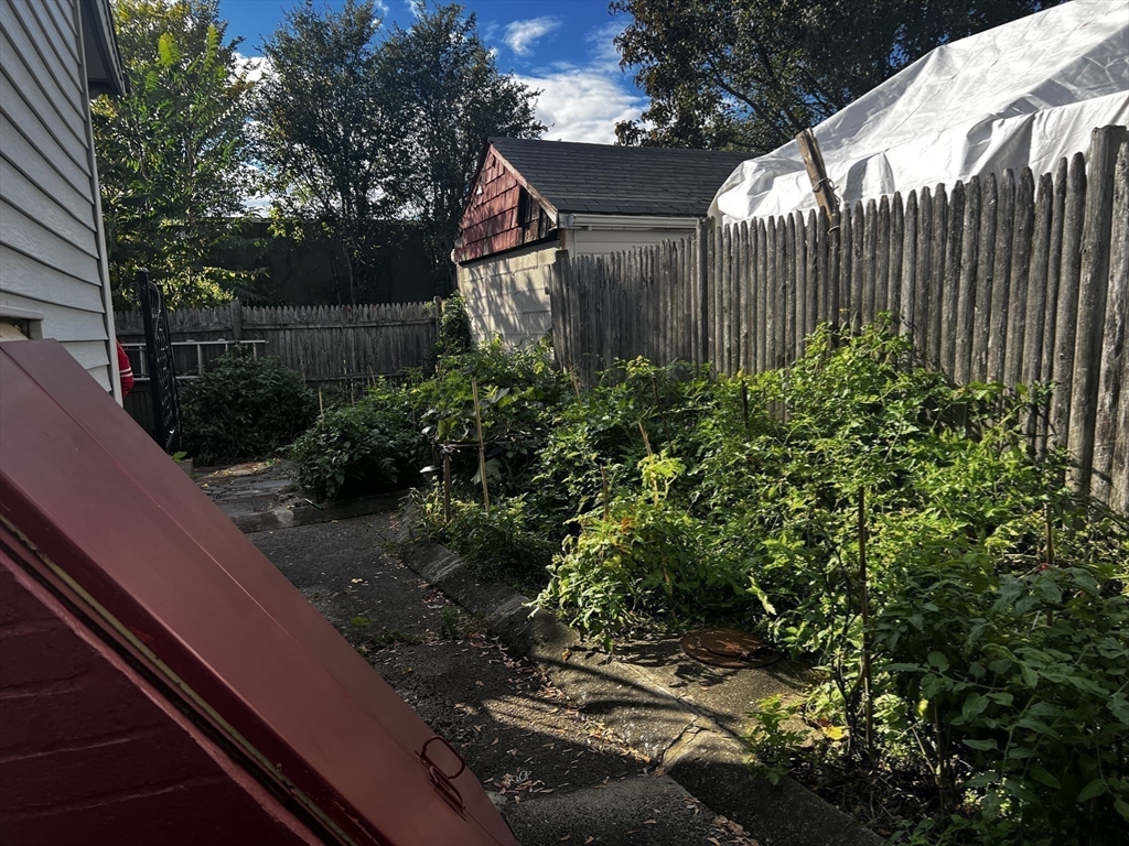15 Neptune St Court Lynn, MA 01905 - Photo 32 of 35 a backyard of a house with lots of green space