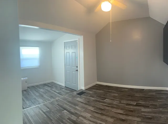 a view of a livingroom with wooden floor and window