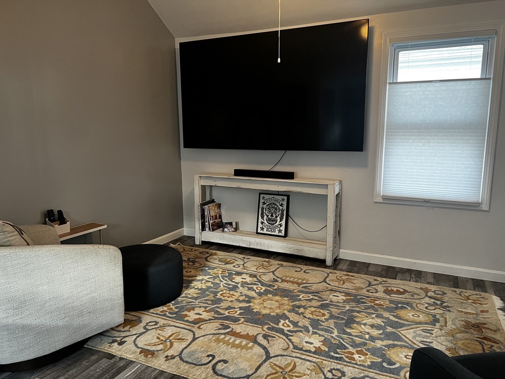 15 Neptune St Court Lynn, MA 01905 - Photo 5 of 35 a living room with a flat screen tv and a fireplace