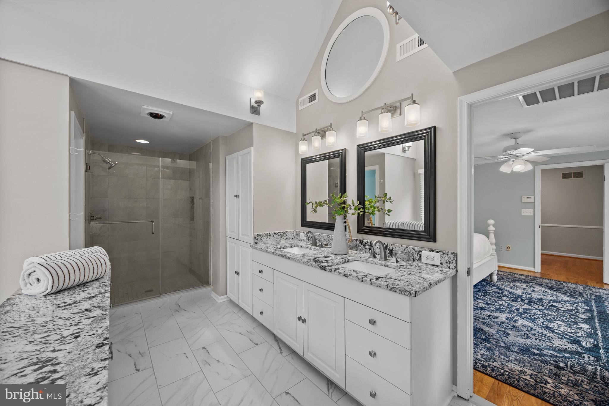 3484 Olympia Road Davidsonville, MD 21035 - Photo 27 of 50 a spacious bathroom with a granite countertop sink mirror and shower
