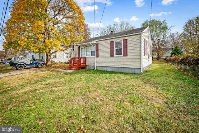 a view of a house with a yard and sitting area