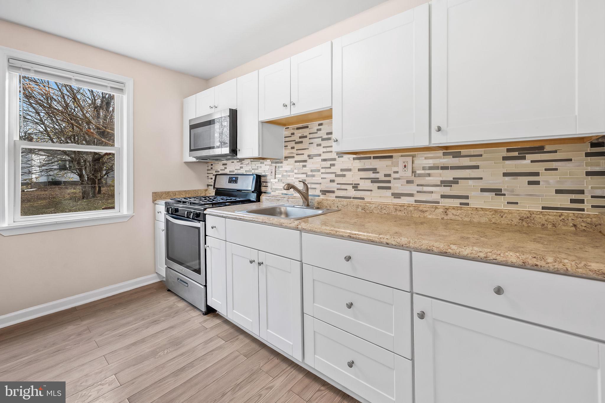 46 Aberdeen Avenue Aberdeen, MD 21001 - Photo 8 of 23 a kitchen with granite countertop white cabinets and stainless steel appliances