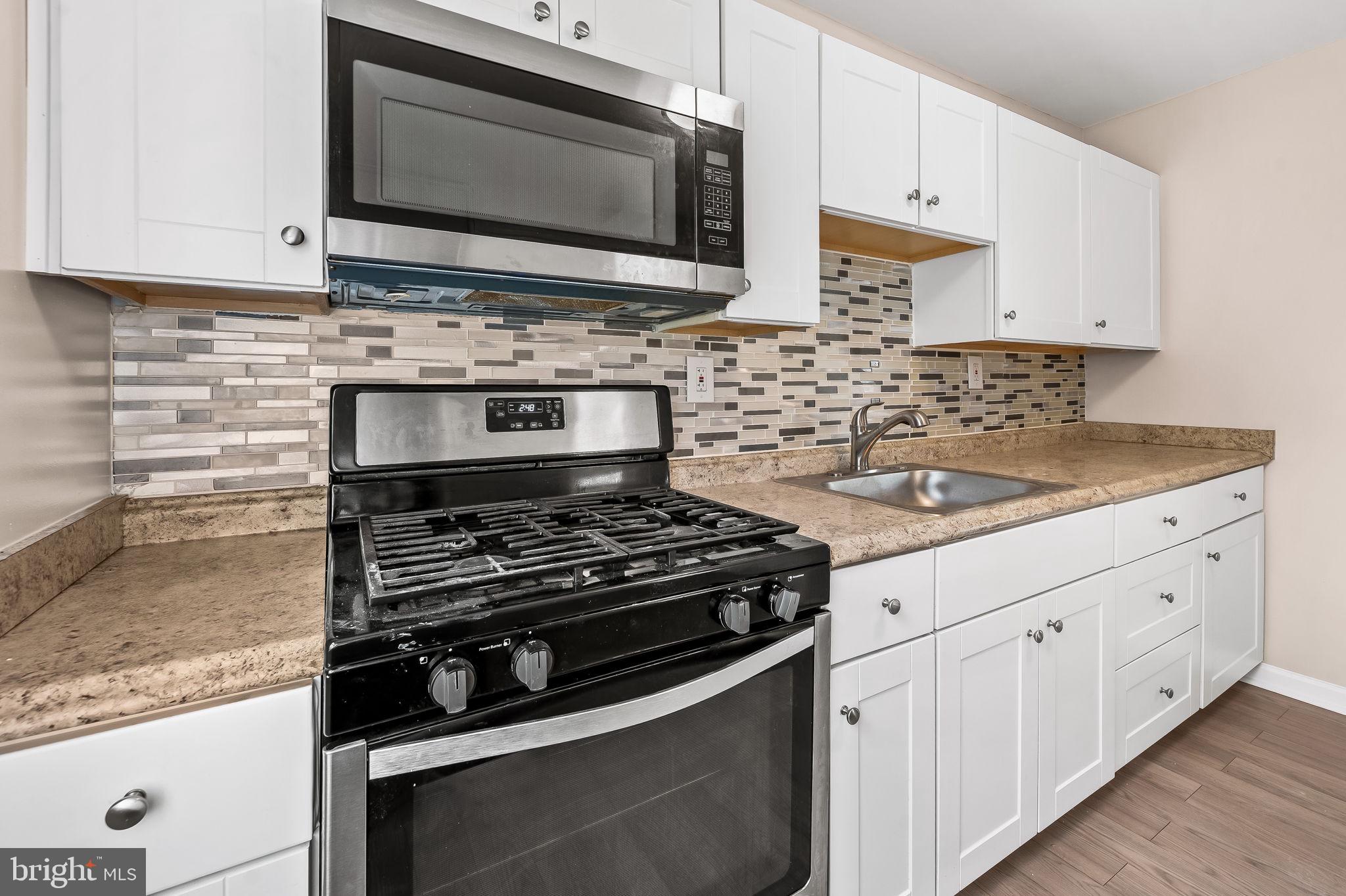 46 Aberdeen Avenue Aberdeen, MD 21001 - Photo 9 of 23 a kitchen with white cabinets and appliances