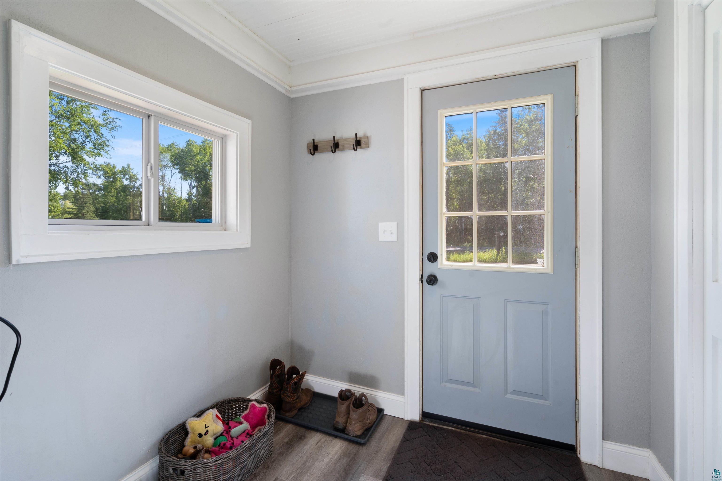 3835 South County Rd K South Range, WI 54874 - Photo 15 of 29 Entryway featuring a light blue paneled door with divided lites, white trim, and a horizontal window