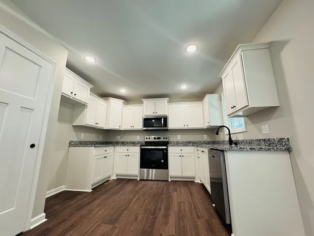 a kitchen with a sink a stove and cabinets