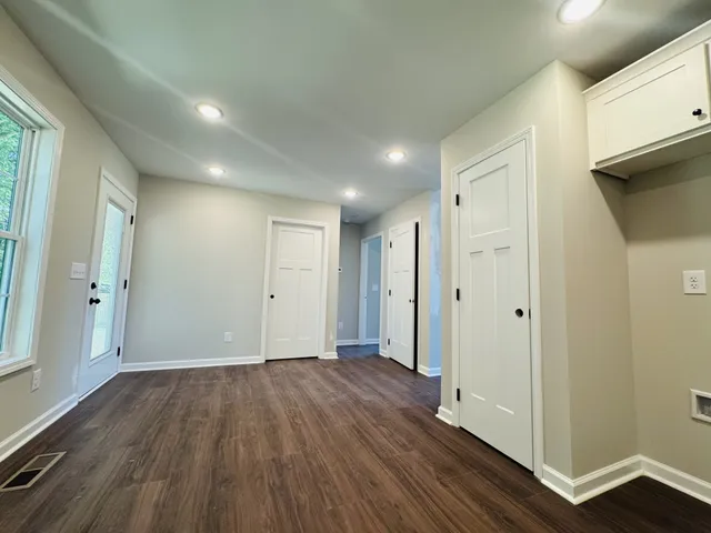a view of hallway with wooden floor