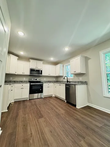 a kitchen with a white cabinets and appliances
