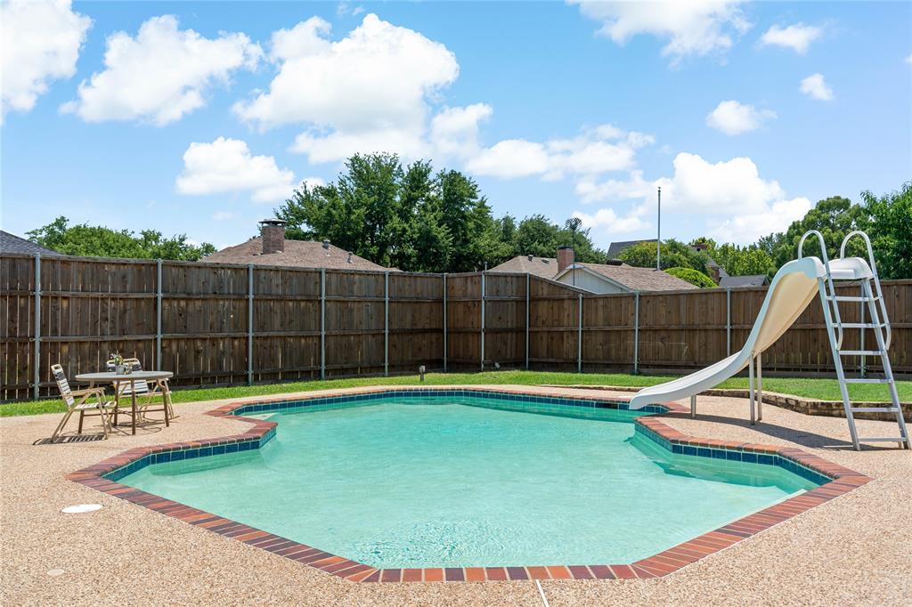 a view of a backyard with swimming pool