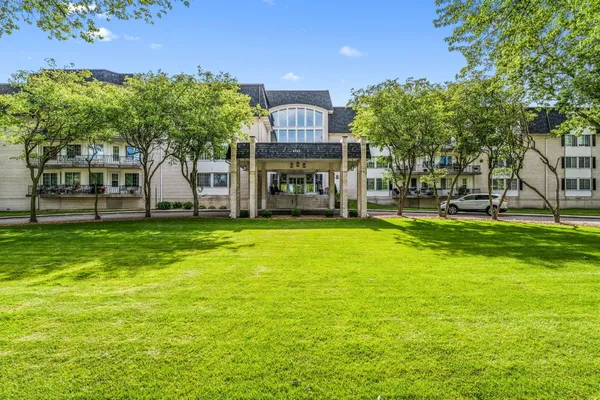 a view of a big yard with a house in the background