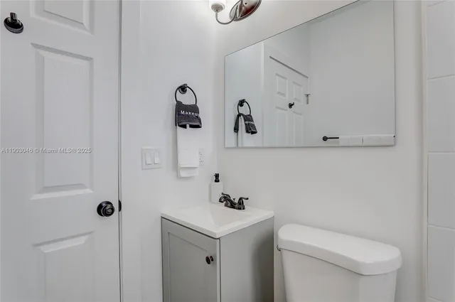 a bathroom with a sink a toilet and shower curtain