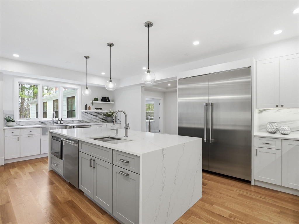 22 Lincoln Road Lincoln, MA 01773 - Photo 12 of 42 a kitchen with kitchen island white cabinets and refrigerator