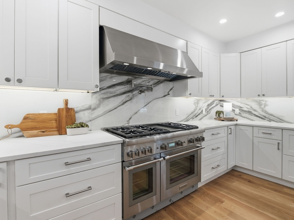 22 Lincoln Road Lincoln, MA 01773 - Photo 13 of 42 a kitchen with stainless steel appliances granite countertop a stove and a sink