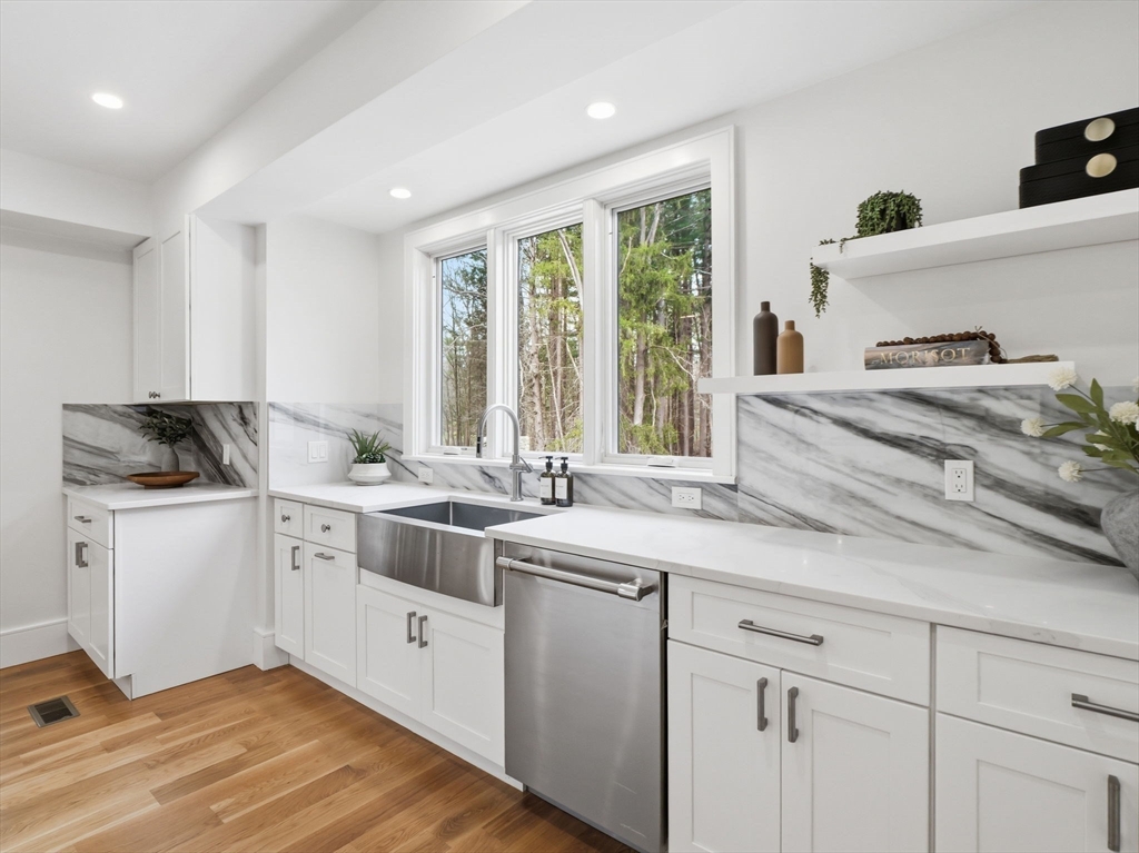 22 Lincoln Road Lincoln, MA 01773 - Photo 14 of 42 a kitchen with granite countertop white cabinets and white appliances