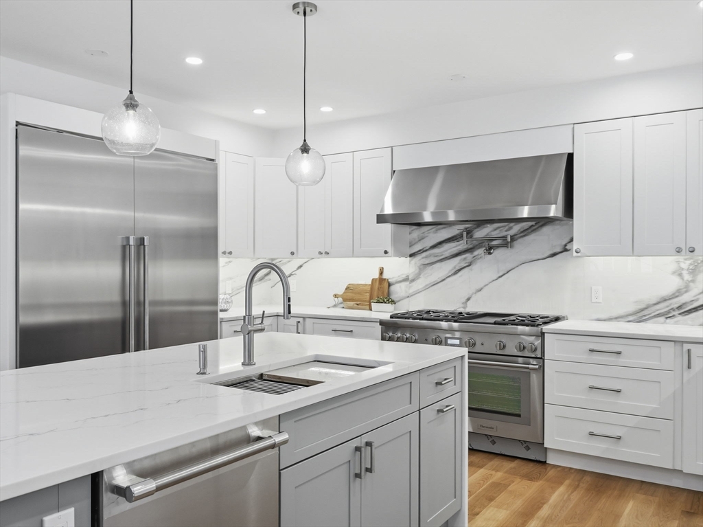 22 Lincoln Road Lincoln, MA 01773 - Photo 15 of 42 a kitchen with stainless steel appliances granite countertop a sink a stove and a refrigerator