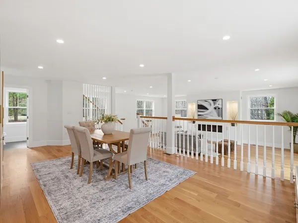 a view of a dining room with furniture a chandelier and wooden floor