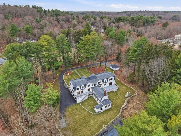 an aerial view of a house with garden space and mountain view