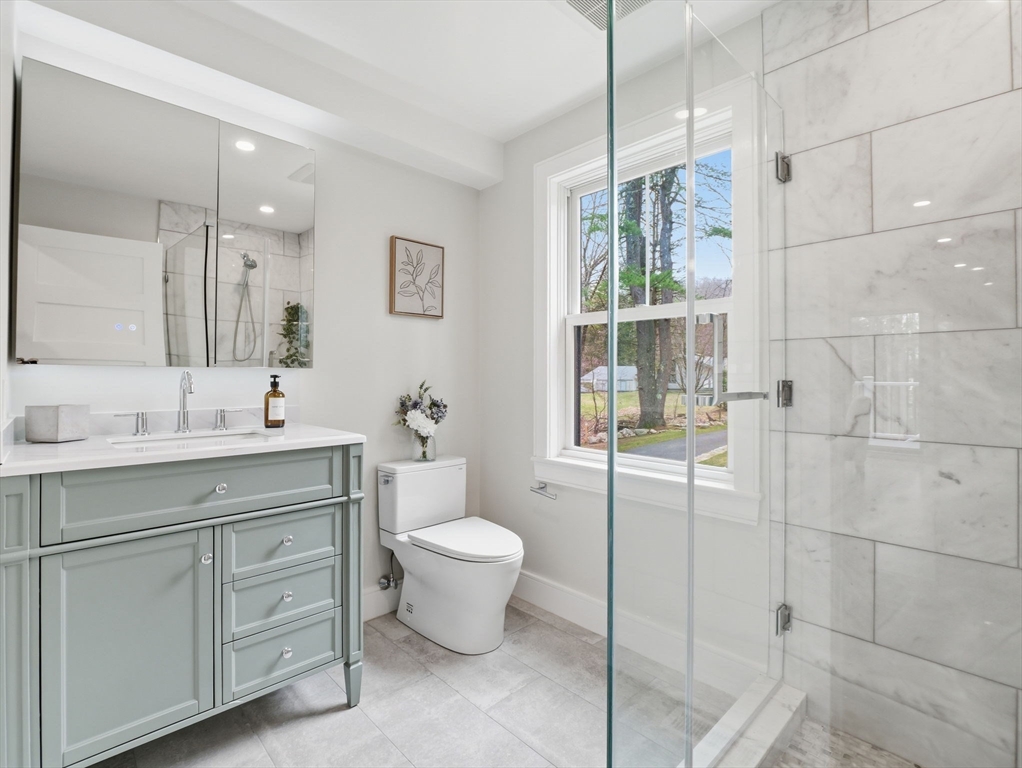 22 Lincoln Road Lincoln, MA 01773 - Photo 25 of 42 a spacious bathroom with a double vanity sink a toilet and a mirror