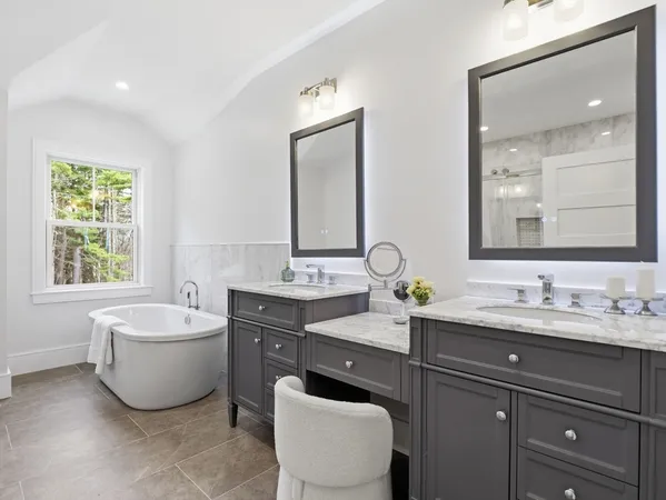 a spacious bathroom with a granite countertop sink a mirror and a shower