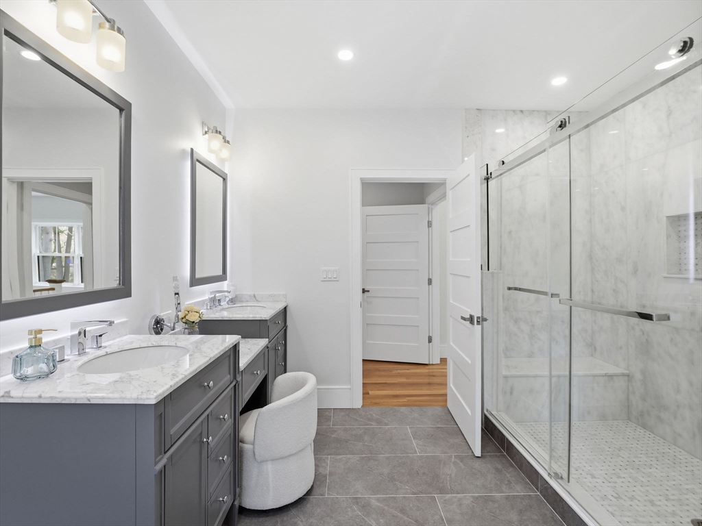 22 Lincoln Road Lincoln, MA 01773 - Photo 29 of 42 a spacious bathroom with a granite countertop sink a mirror and a shower