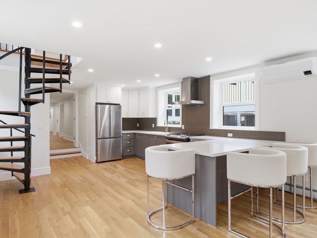 22 Lincoln Road Lincoln, MA 01773 - Photo 35 of 42 a kitchen with refrigerator and chairs