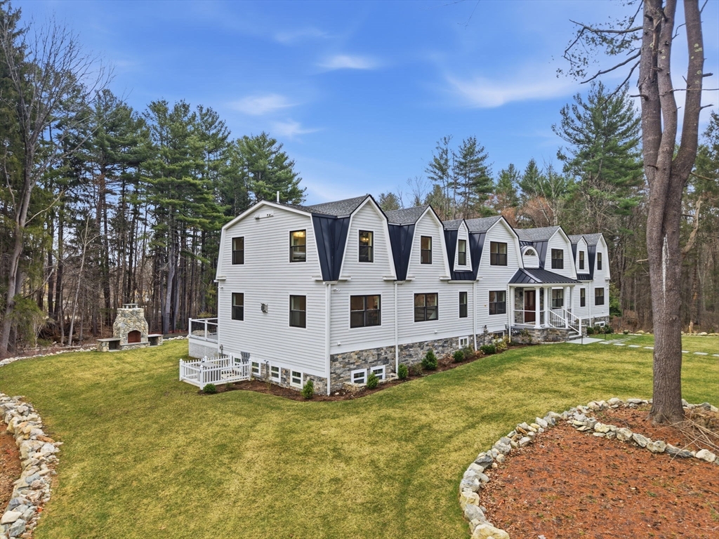 22 Lincoln Road Lincoln, MA 01773 - Photo 40 of 42 a view of a white house with a big yard and large trees
