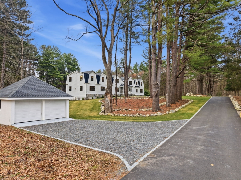 22 Lincoln Road Lincoln, MA 01773 - Photo 41 of 42 a view of a house with large trees and covered with snow