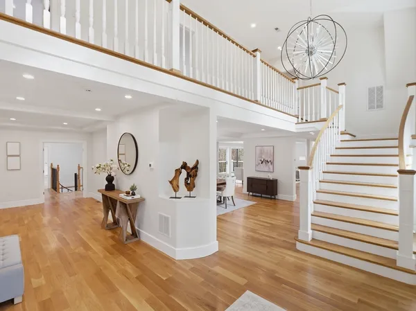 a view of a livingroom with wooden floor and a ceiling fan