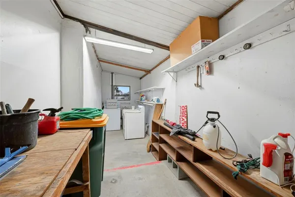 a living room with furniture a flat screen tv and floor to ceiling window