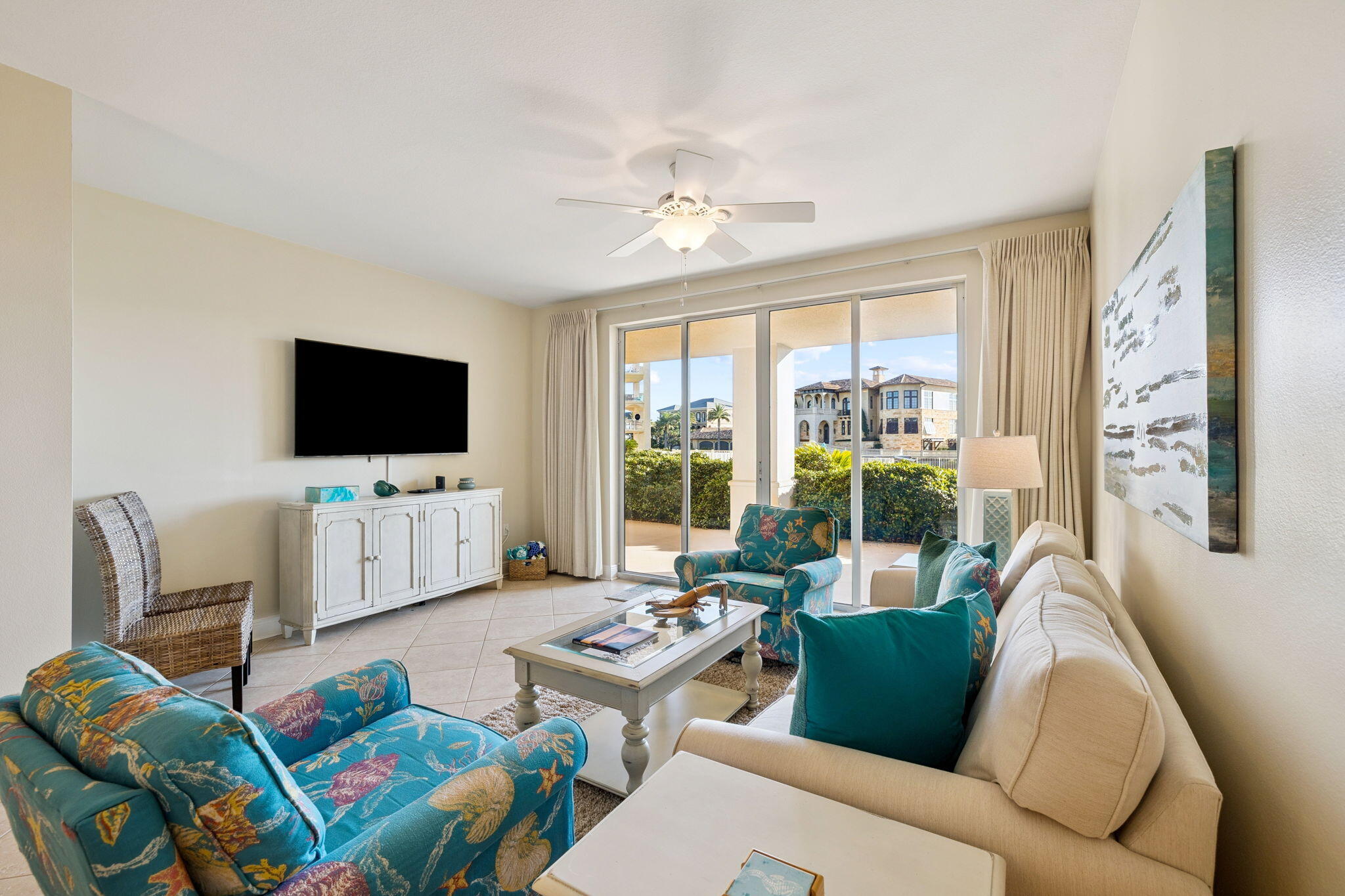 4045 West County Highway 30A, Unit 108 Santa Rosa Beach, FL 32459 - Photo 5 of 29 a living room with furniture a flat screen tv and a floor to ceiling window