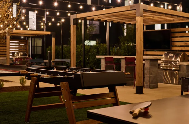 a view of a patio with table and chairs with wooden floor and fence