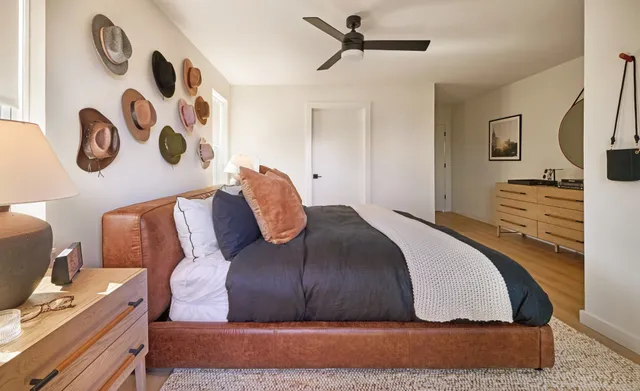 a bedroom with a bed and wooden floor