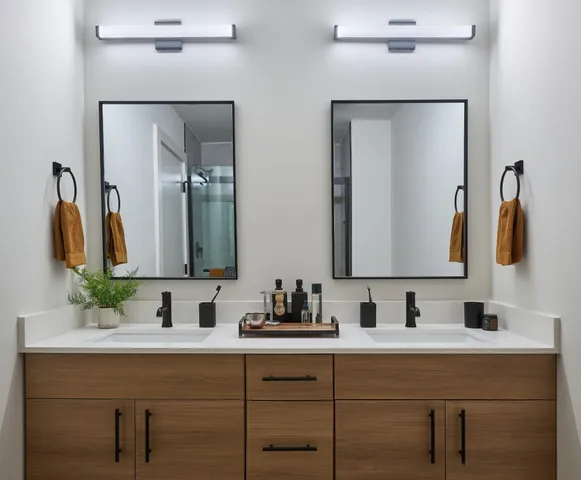a bathroom with double vanity sinks and a mirror