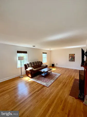a bedroom with furniture and a wooden floor