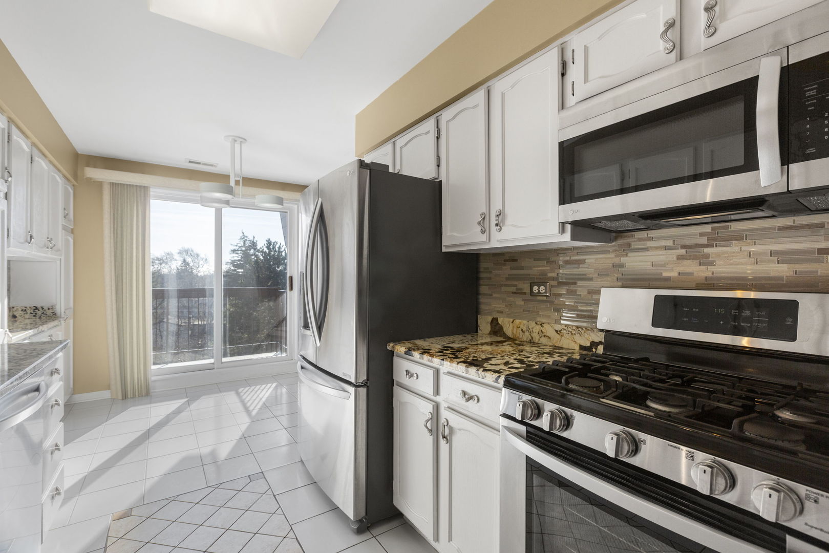 400 East Dundee Road, Unit 403C Buffalo Grove, IL 60089 - Photo 6 of 20 a kitchen with stainless steel appliances a stove a microwave and a sink