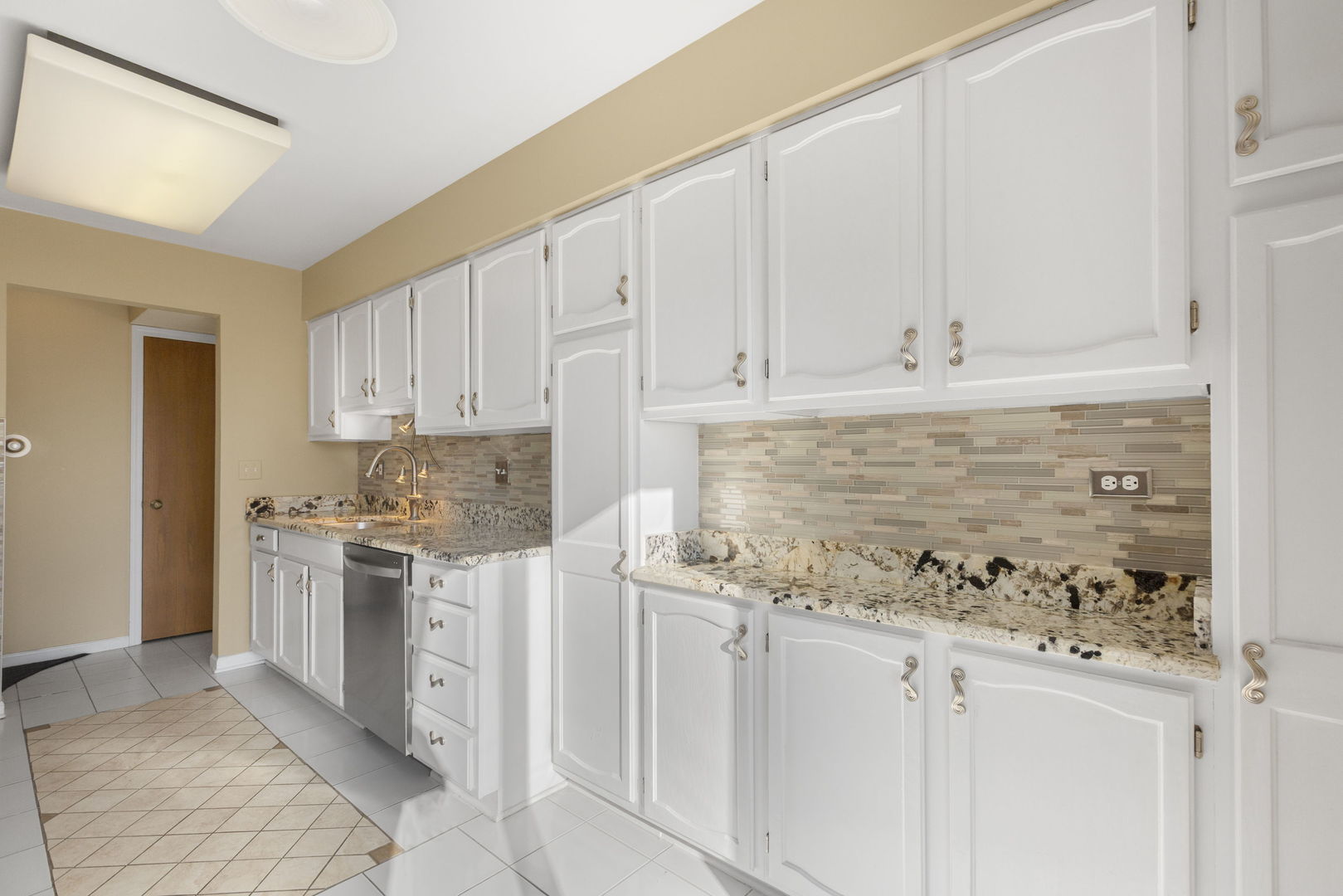 400 East Dundee Road, Unit 403C Buffalo Grove, IL 60089 - Photo 8 of 20 a kitchen with stainless steel appliances granite countertop a stove and a refrigerator