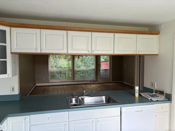 a kitchen with granite countertop a sink and a window