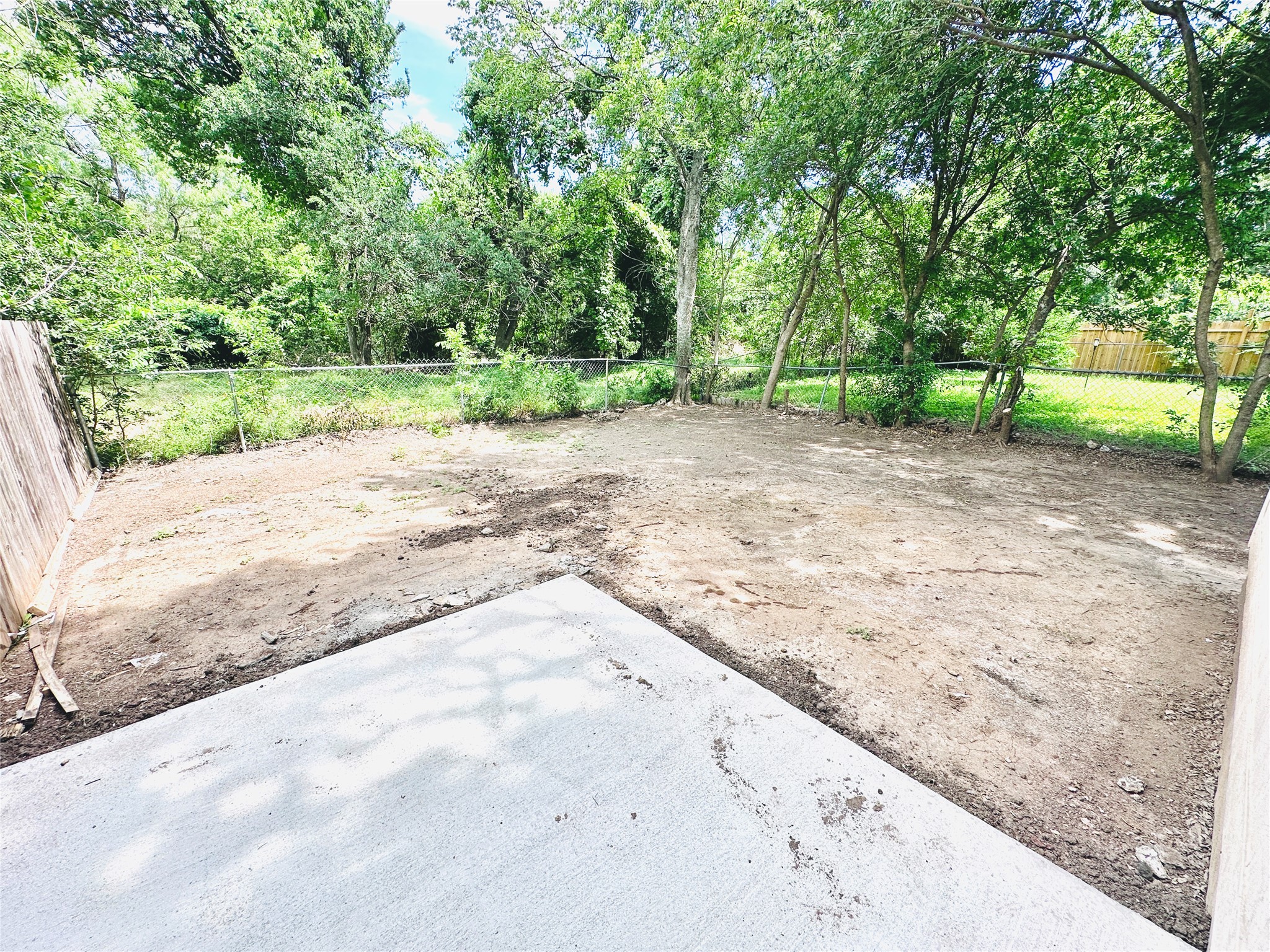 12505 Turtle Rock Road, Unit A Austin, TX 78729 - Photo 35 of 38 Ready for landscaping, this ample yard offers a private retreat surrounded by mature trees.
