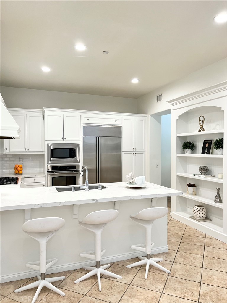 22 San Sovino Newport Coast, CA 92657 - Photo 12 of 20 a kitchen with stainless steel appliances kitchen island granite countertop a sink and cabinets