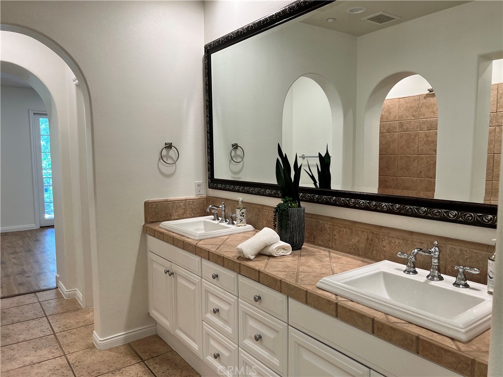 22 San Sovino Newport Coast, CA 92657 - Photo 17 of 20 a bathroom with double vanity sinks and a mirror