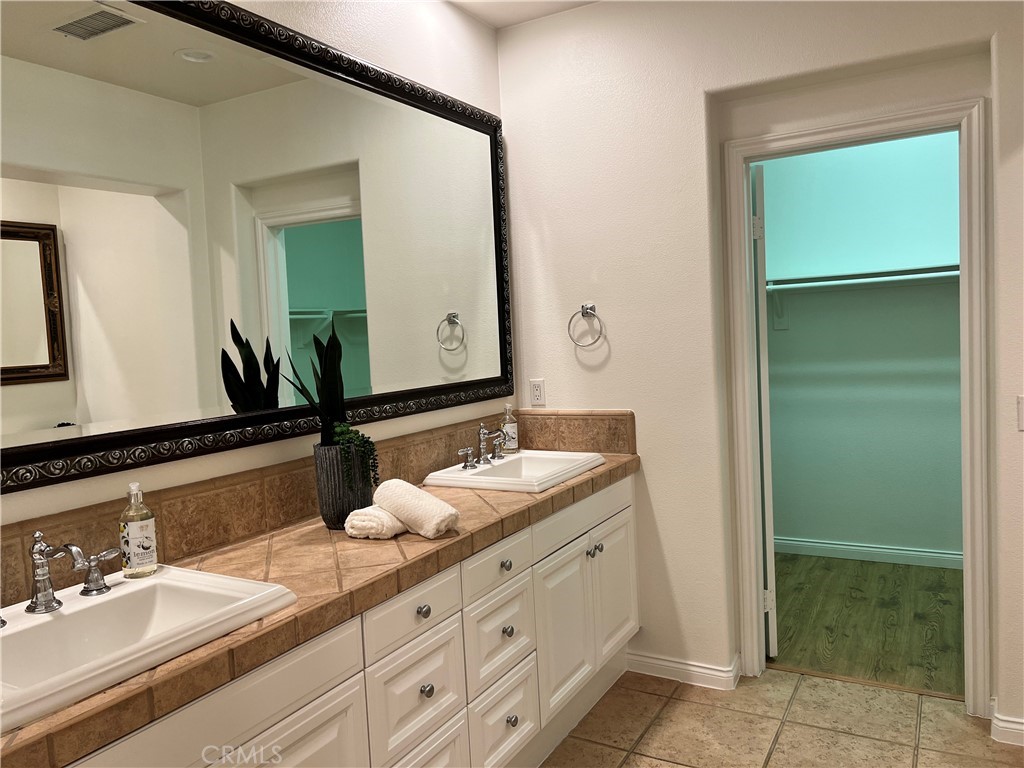 22 San Sovino Newport Coast, CA 92657 - Photo 18 of 20 a bathroom with a granite countertop sink and a mirror