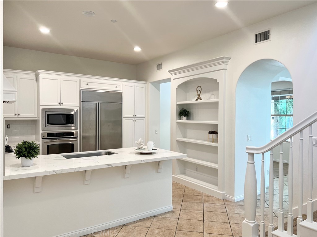 22 San Sovino Newport Coast, CA 92657 - Photo 19 of 20 a kitchen with stainless steel appliances a sink and a refrigerator