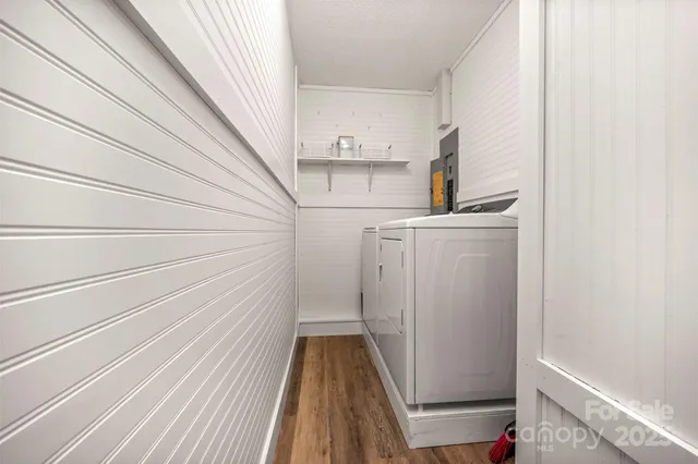a view of storage and utility room with wooden floor