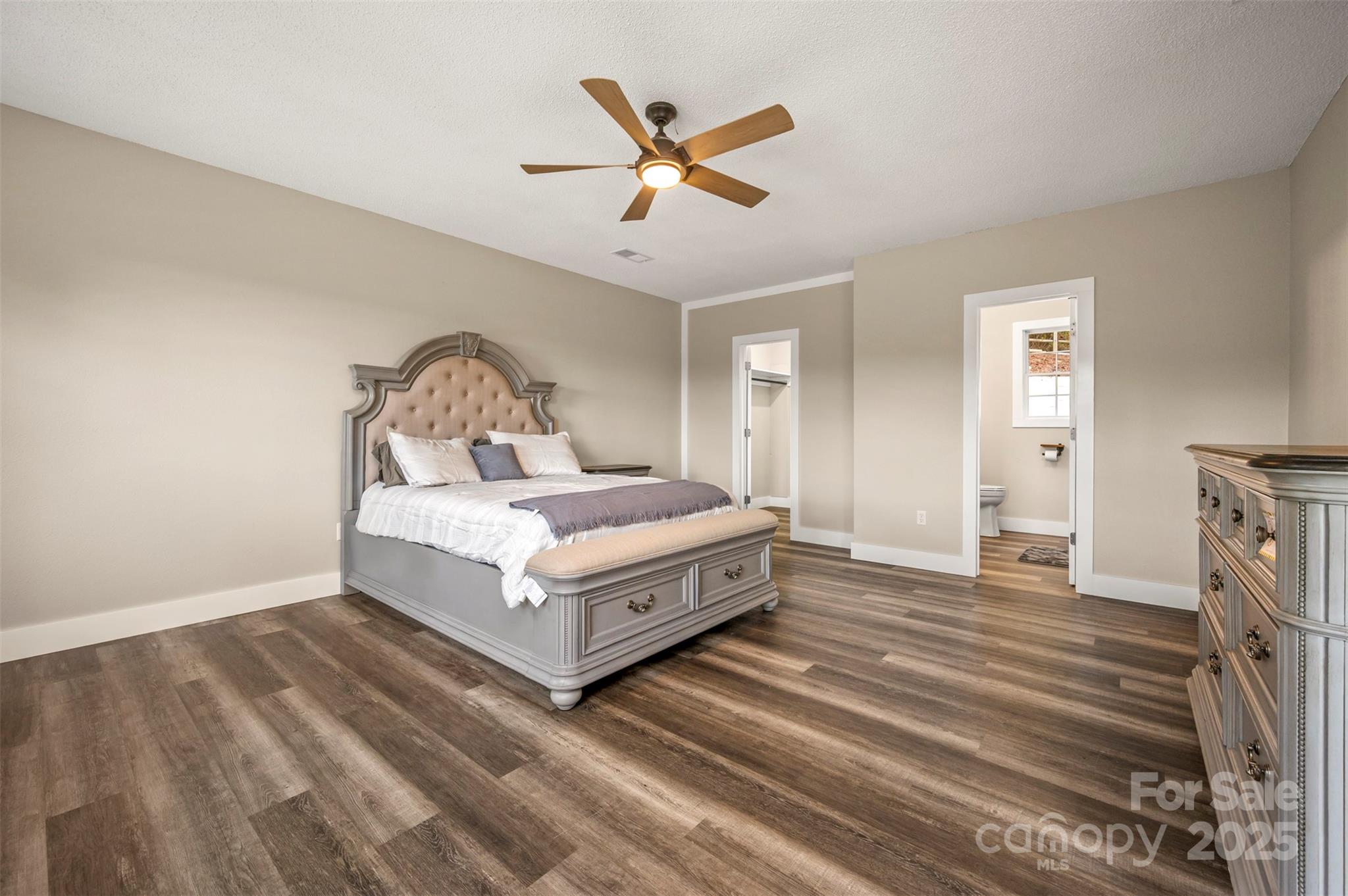 569 Lanning Road Hendersonville, NC 28792 - Photo 15 of 32 a living room with a bed furniture and a ceiling fan