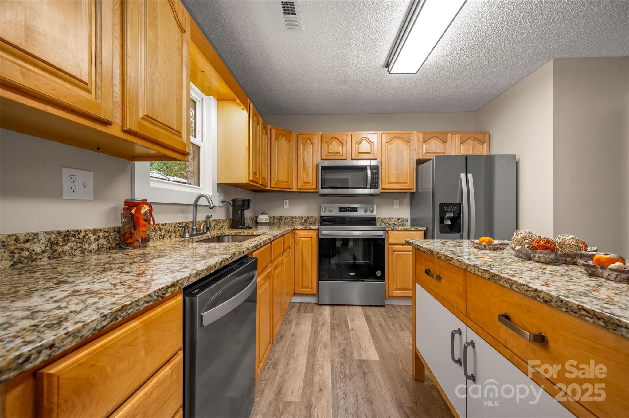 569 Lanning Road Hendersonville, NC 28792 - Photo 19 of 32 a kitchen with stainless steel appliances granite countertop a stove a sink and a refrigerator